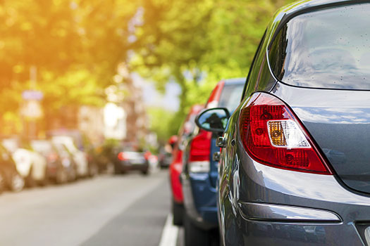 Rows of cars parked on the roadside in residential district